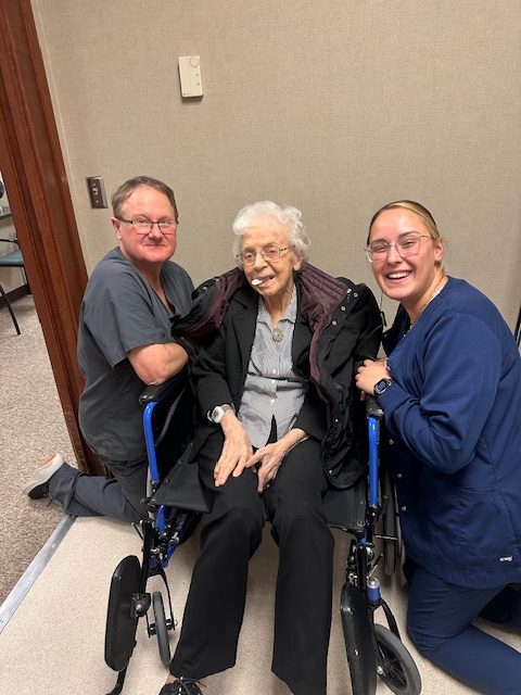 100 club member - woman with dr. miller and another team member